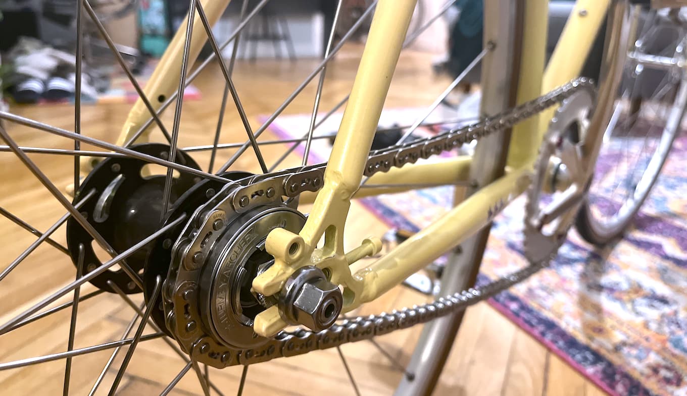 Detail of a bicycle chain and Sturmey Archer freewheel on a bicycle